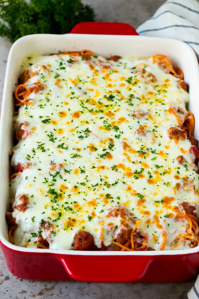 Baked Spaghetti Recipe | Baked Pasta #spaghetti #pasta #cheese #casserole #beef #sausage #dinner #bajap Spaghetti in a baking dish with melted cheese baked on top.