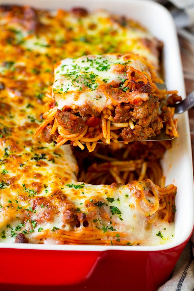 Baked Spaghetti Recipe | Baked Pasta #spaghetti #pasta #cheese #casserole #beef #sausage #dinner #bajap A spatula holding up a serving of baked spaghetti.