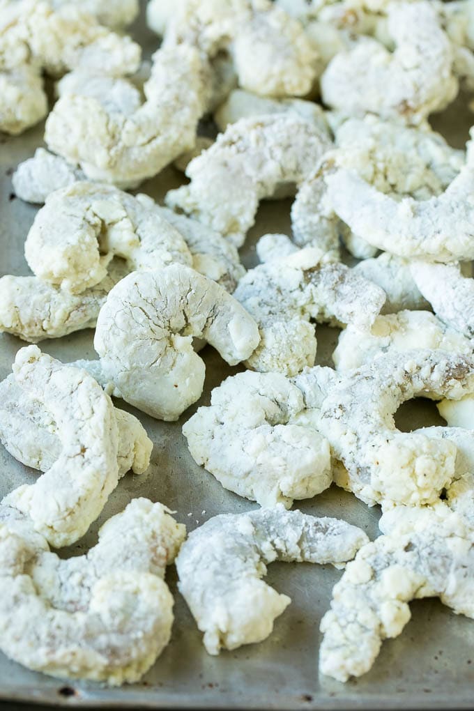 Bang Bang Shrimp Recipe | Fried Shrimp #shrimp #appetizer #dinner #bajap #copycatrecipe Shrimp coated in cornstarch on a sheet pan.