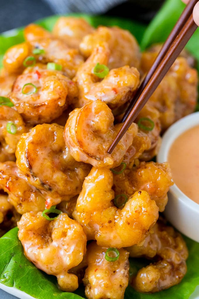 Bang Bang Shrimp Recipe | Fried Shrimp #shrimp #appetizer #dinner #bajap #copycatrecipe A pair of chopsticks picking up bang bang shrimp.