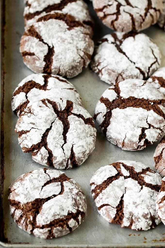 Chocolate Crinkle Cookies Recipe #cookies #chocolate #christmas #dessert #baking #bajap Crinkle cookies on a sheet pan.