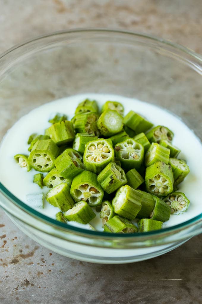 Fried Okra Recipe #okra #appetizer #sidedish #bajap Sliced okra in a bowl of buttermilk.