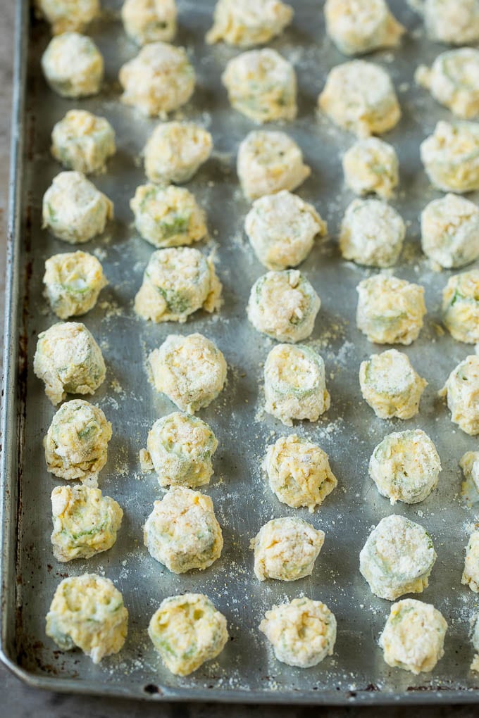 Fried Okra Recipe #okra #appetizer #sidedish #bajap Breaded okra slices on a sheet pan.