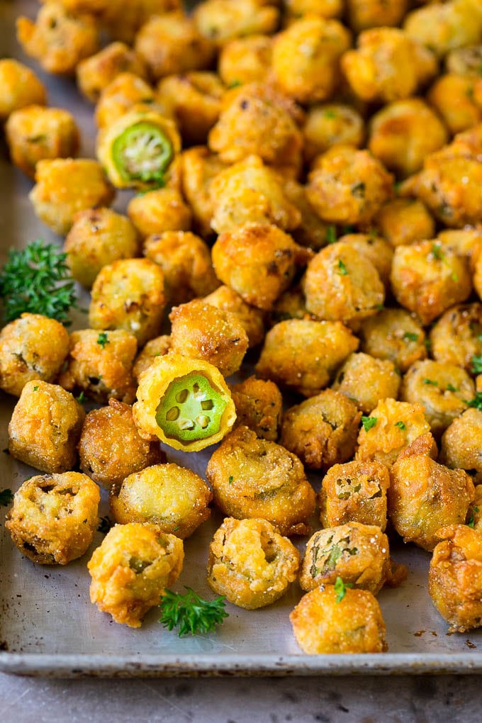 Fried Okra Recipe #okra #appetizer #sidedish #bajap Fried okra on a sheet pan, garnished with chopped parsley.