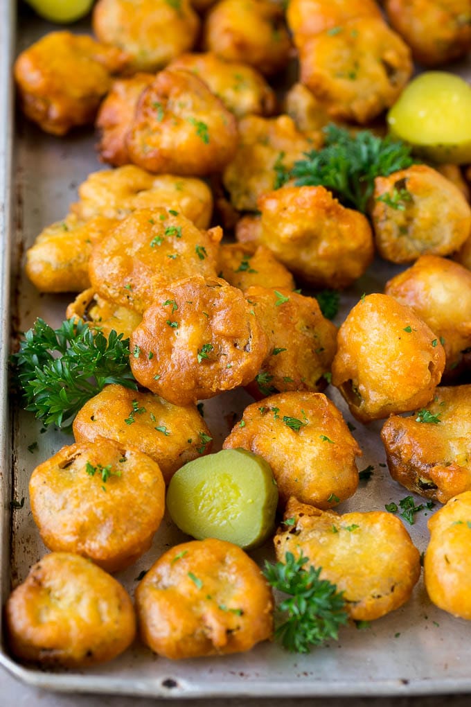 Fried Pickles Recipe #pickles #appetizer #snack #bajap Fried pickles on a sheet pan, garnished with parsley.