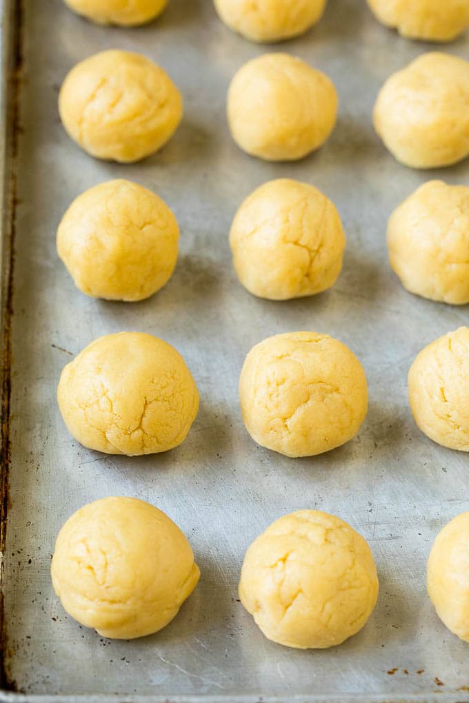 Italian Cookies Recipe | Almond Cookies #cookies #italianfood #frosting #sprinkles #baking #christmas #bajap Balls of cookie dough on a sheet pan.