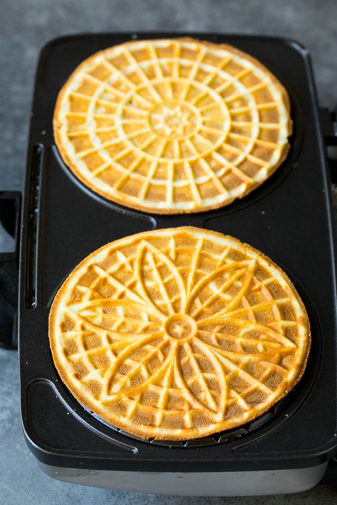 Pizzelle Cookies Recipe #cookies #baking #dessert #christmas #bajap Baked cookies inside a pizzelle iron.
