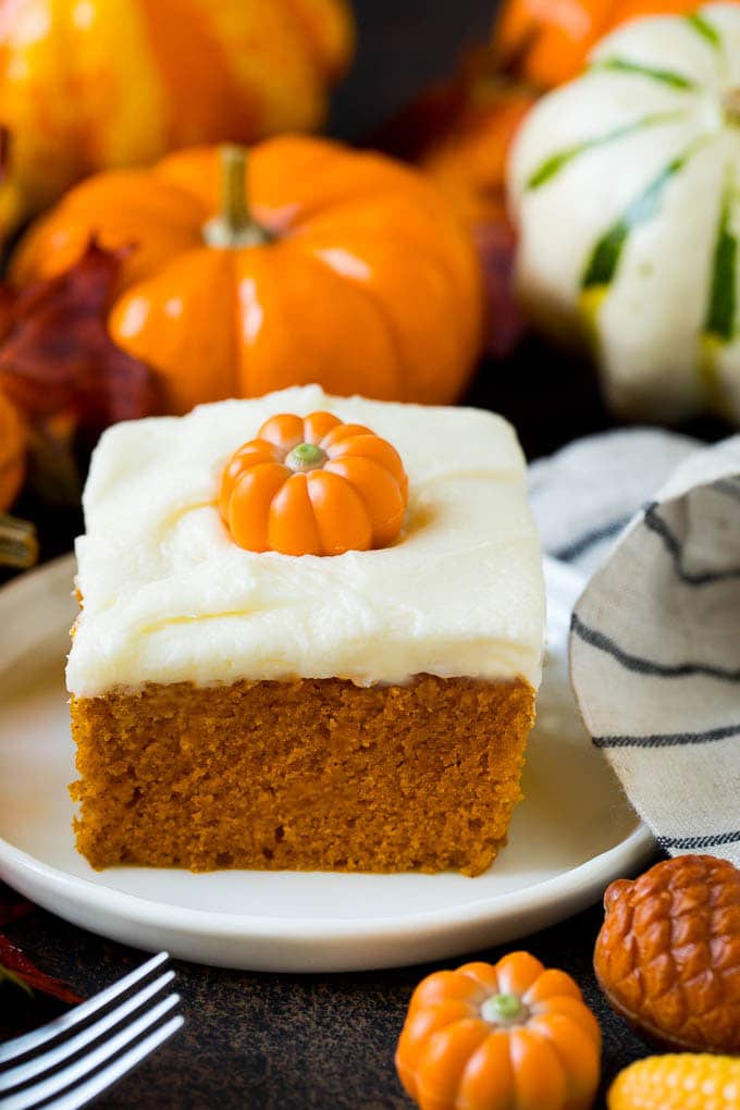Pumpkin Cake Recipe | Pumpkin Spice Cake #cake #pumpkin #dessert #baking #fall #thanksgiving #bajap A slice of pumpkin cake topped with cream cheese frosting.