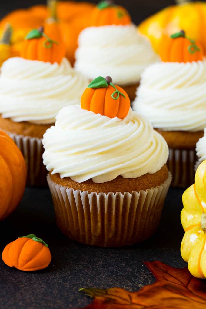 Pumpkin Cupcakes Recipe | Pumpkin Cake #cake #cupcakes #pumpkin #frosting #baking #fall #thanksgiving #bajap Pumpkin cupcakes topped with cream cheese frosting and candy pumpkins.