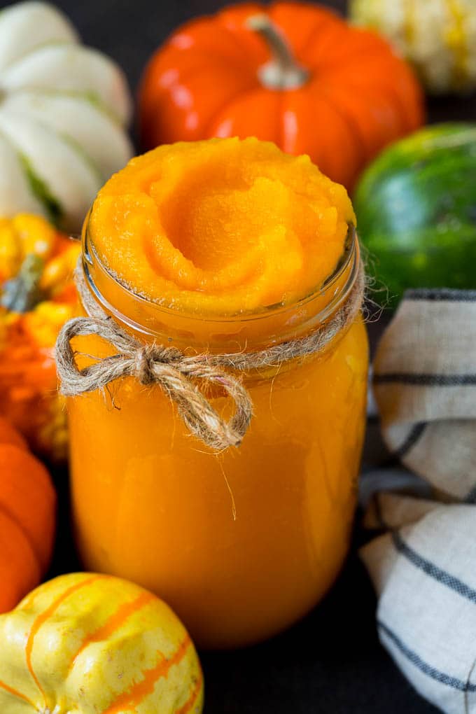 Pumpkin Puree Recipe #pumpkin #baking #fall #thanksgiving #bajap A jar of pumpkin puree surrounded by fall produce.
