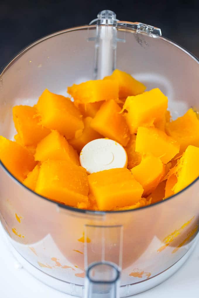 Pumpkin Puree Recipe #pumpkin #baking #fall #thanksgiving #bajap Cubes of pumpkin in a food processor.
