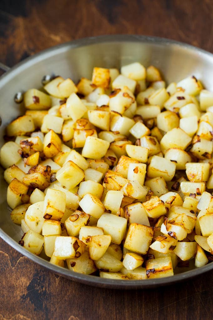 Corned Beef Hash Recipe #hash #cornedbeef #stpatricksday #breakfast #brunch #potatoes #bajap Sauteed potatoes in a skillet.