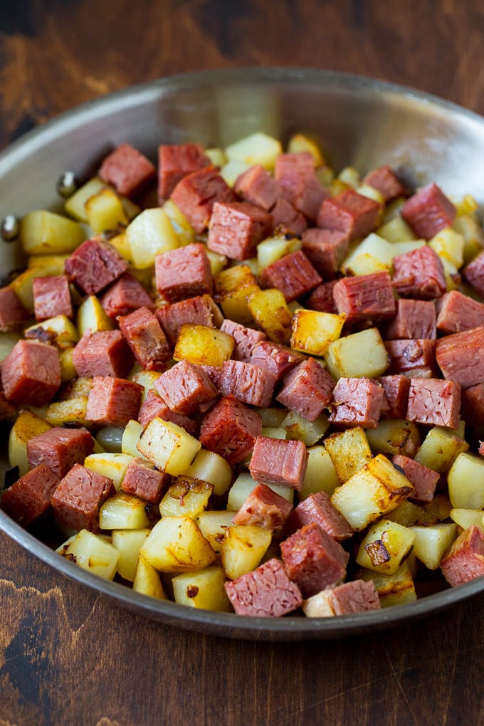 Corned Beef Hash Recipe #hash #cornedbeef #stpatricksday #breakfast #brunch #potatoes #bajap Corned beef and potatoes cooked together in a pan.