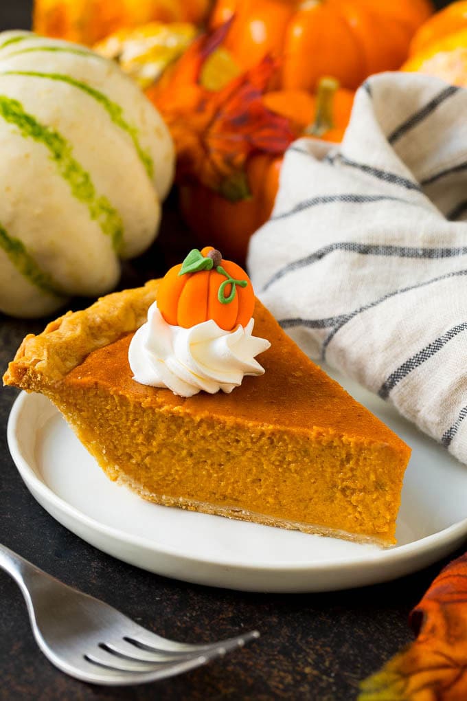 Homemade Pumpkin Pie Recipe | Pumpkin Pie #pie #pumpkin #baking #thanksgiving #fall #dessert #bajap A slice of homemade pumpkin pie topped with whipped cream and a candy pumpkin.