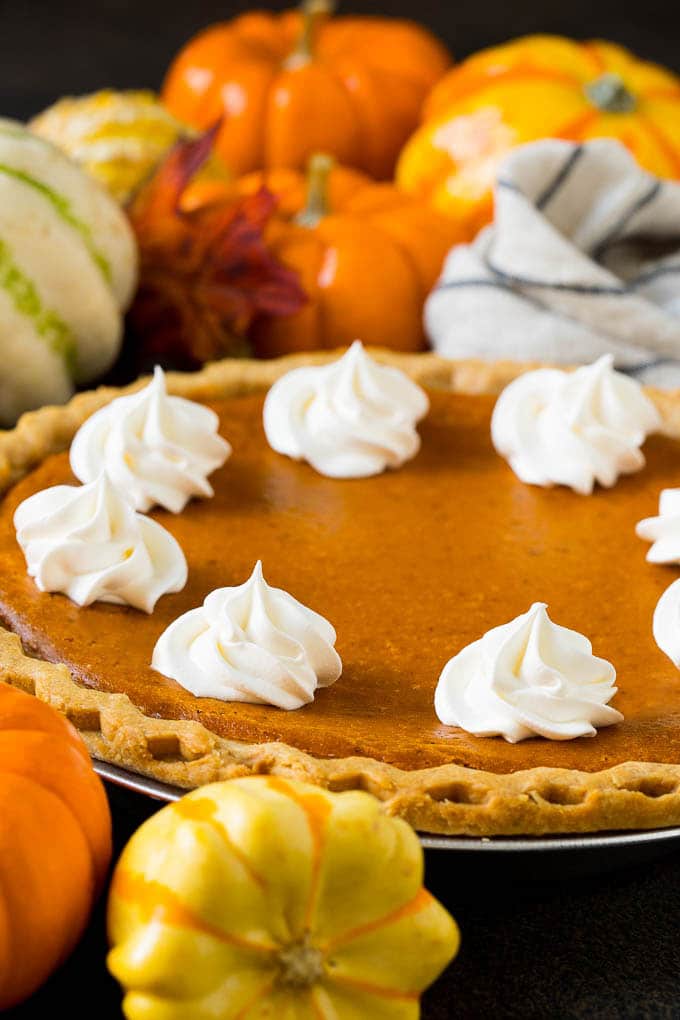 Homemade Pumpkin Pie Recipe | Pumpkin Pie #pie #pumpkin #baking #thanksgiving #fall #dessert #bajap Homemade pumpin pie topped with rosettes of whipped cream.