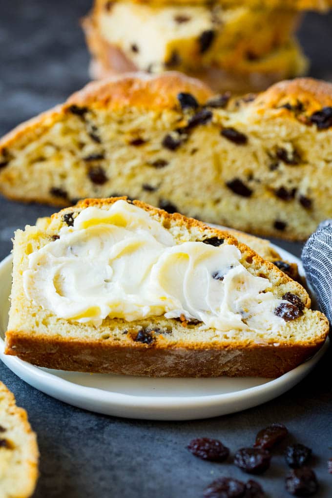 Irish Soda Bread Recipe #bread #baking #stpatricksday #sidedish #bajap A slice of Irish soda bread with butter spread on it.