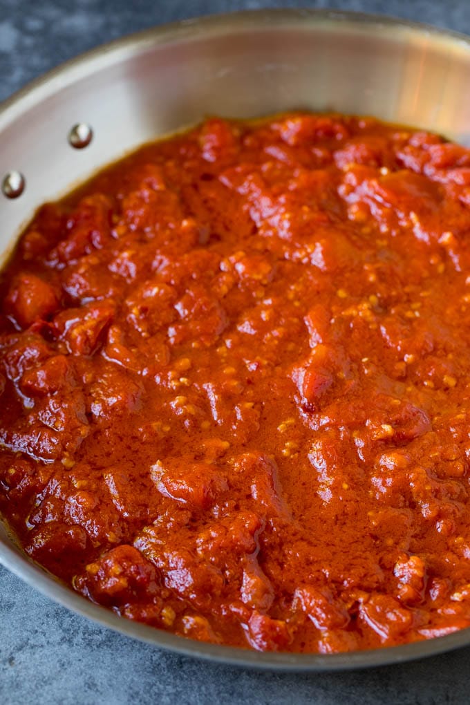 Pasta Puttanesca Recipe #pasta #tomatoes #olives #italianfood #dinner #bajap Homemade tomato sauce in a skillet.