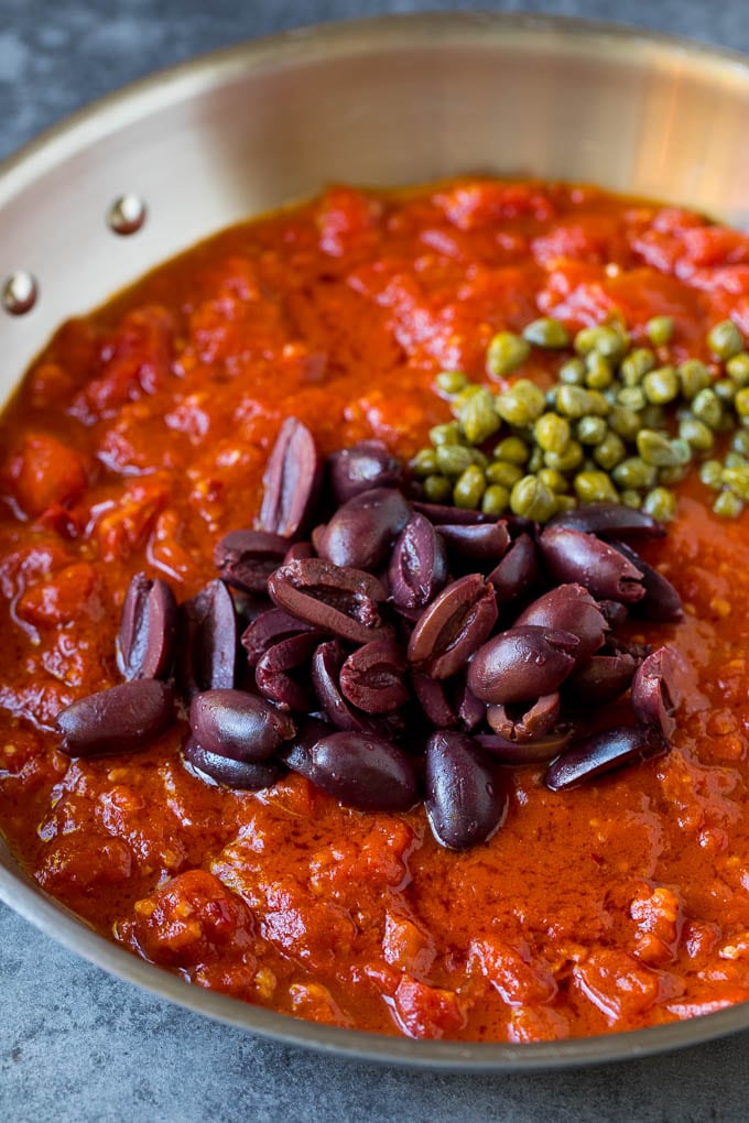 Pasta Puttanesca Recipe #pasta #tomatoes #olives #italianfood #dinner #bajap Tomato sauce with olives and capers on top.
