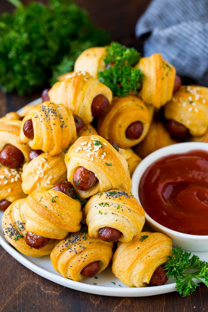 Pigs in a Blanket Recipe #hotdogs #appetizer #snack #comfortfood #bajap A plate of pigs in a blanket served with ketchup.
