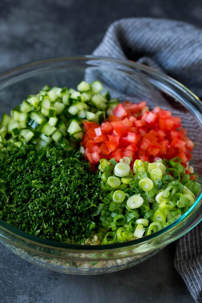 Tabbouleh Salad | Tabouli #salad #wheat #tomatoes #cucumber #healthy #sidedish #dinner #bajap A bowl of bulgur topped with herbs, tomatoes and cucumber.