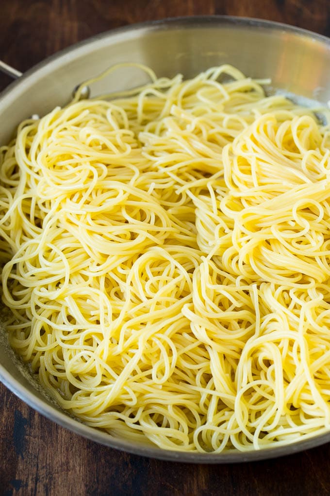 Garlic and Herb Angel Hair Pasta #pasta #garlic #sidedish #dinner #bajap Pasta in a pan with garlic and butter.