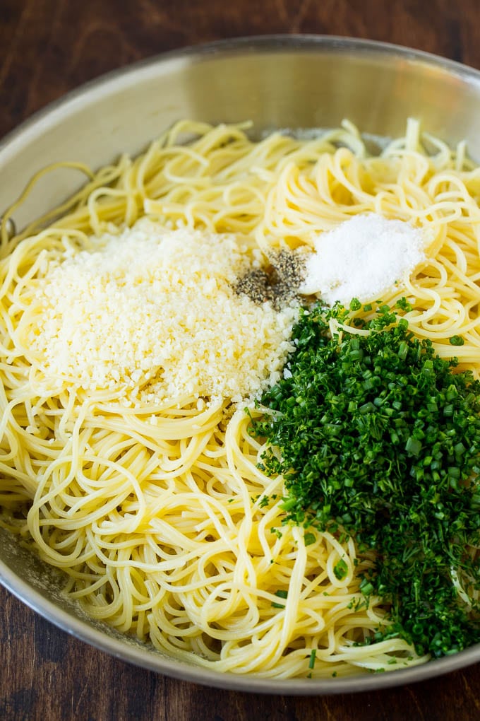Garlic and Herb Angel Hair Pasta #pasta #garlic #sidedish #dinner #bajap Pasta topped with herbs, cheese, salt and pepper.