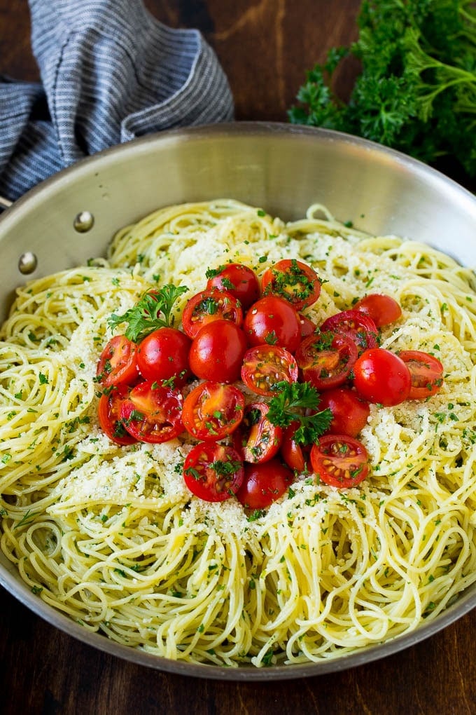 Garlic and Herb Angel Hair Pasta #pasta #garlic #sidedish #dinner #bajap Garlic and herb angel hair pasta topped with fresh tomatoes.