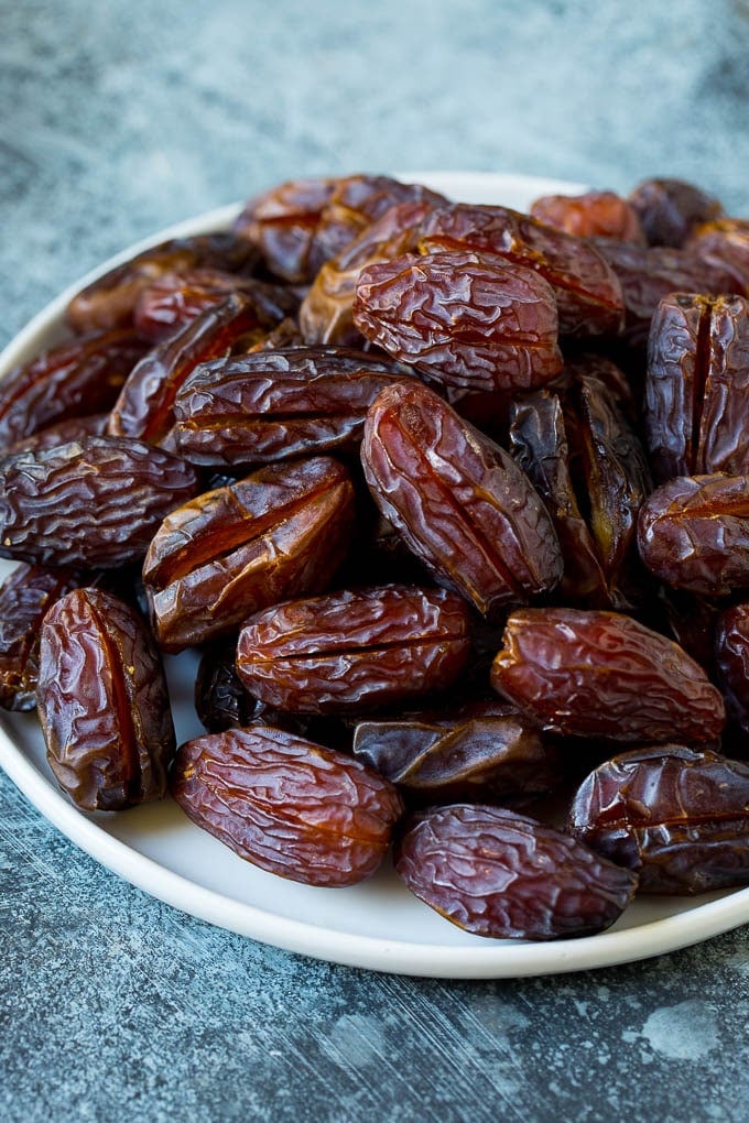 Bacon Wrapped Dates #appetizer #bacon #dates #cheese #bajap Dates split open on a plate.