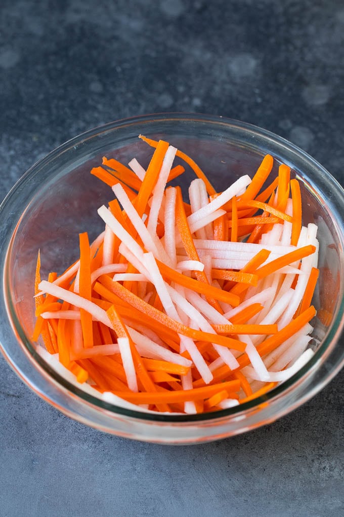 Bahn Mi Sandwich Recipe #sandwich #pork #lunch #dinner #bajap Shredded carrots and daikon radish in a bowl.