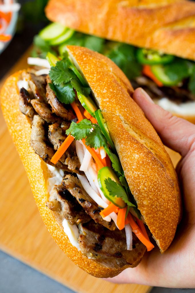 Bahn Mi Sandwich Recipe #sandwich #pork #lunch #dinner #bajap A hand holding a pork banh mi sandwich.