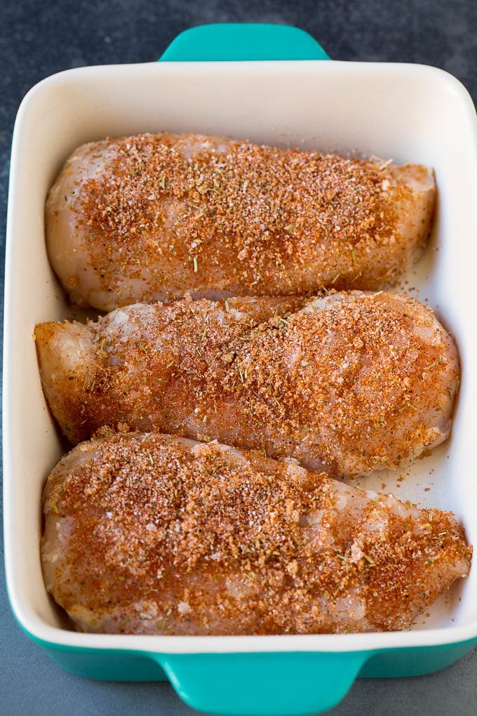 Baked Chicken Breast Recipe #chicken #dinner #bajap Chicken coated in seasonings in a baking dish.