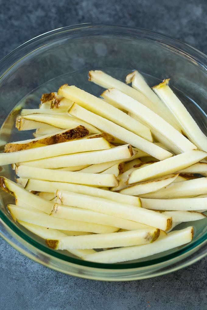 Homemade French Fries Recipe #potatoes #fries #dinner #bajap Sliced potato sticks in a bowl of water.