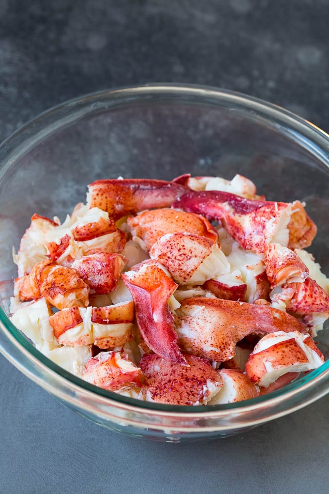 Lobster rolls stuffed with creamy lobster salad in a toasted bun. #lobster #bajap Chunks of lobster meat in a bowl.