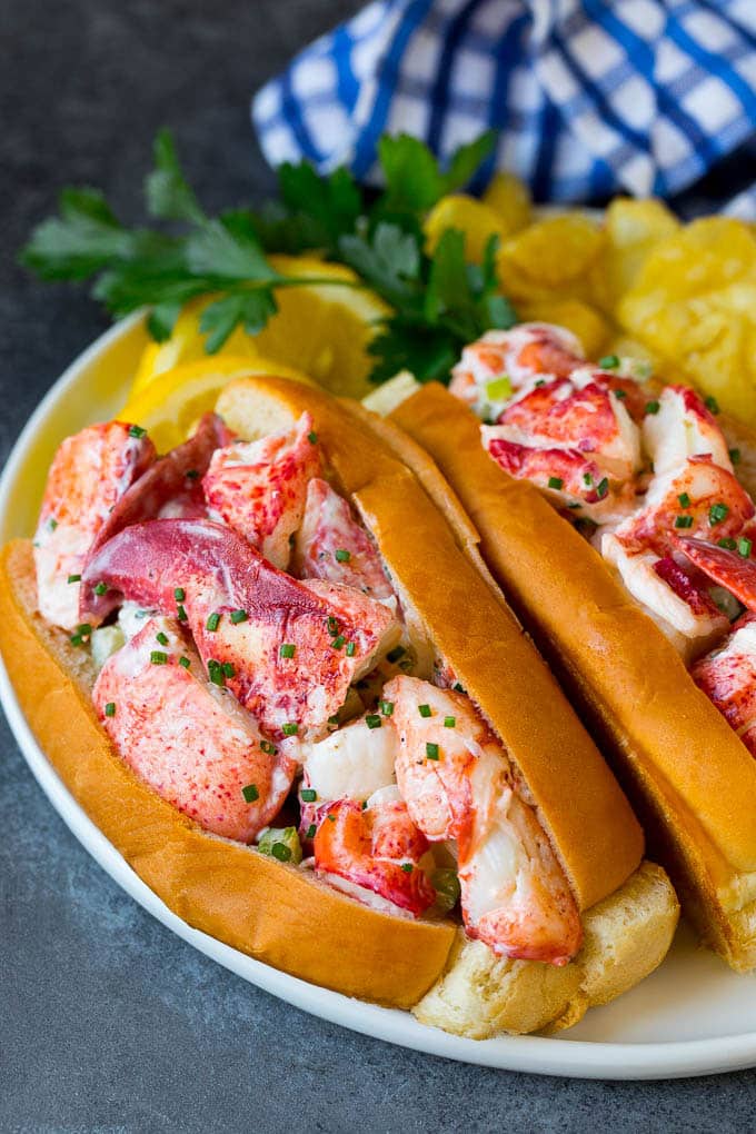 Lobster rolls stuffed with creamy lobster salad in a toasted bun. #lobster #bajap Lobster roll with chunks of fresh lobster meat in a buttered and toasted bun.