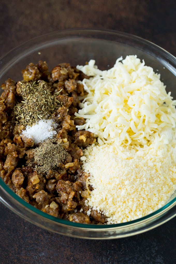 Baked Manicotti Recipe #pasta #cheese #dinner #bajap Sausage, cheeses and herbs in a mixing bowl.