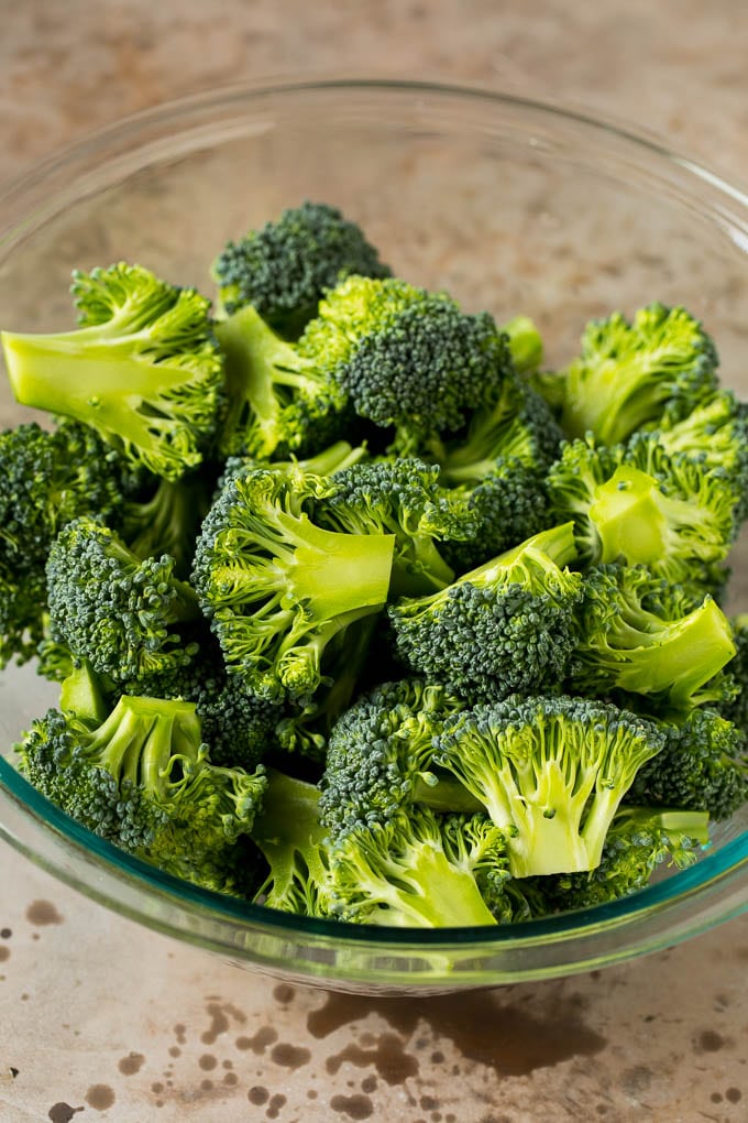 Grilled broccoli is packed with flavor and is a colorful and healthy side dish! #broccoli #bajap Green florets in a bowl.