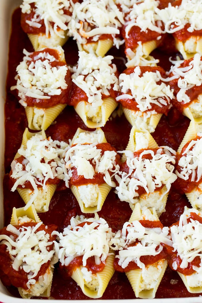 Baked stuffed shells filled with three types of cheese and topped with marinara sauce. #pasta #bajap Filled pasta topped with marinara sauce and shredded cheese.