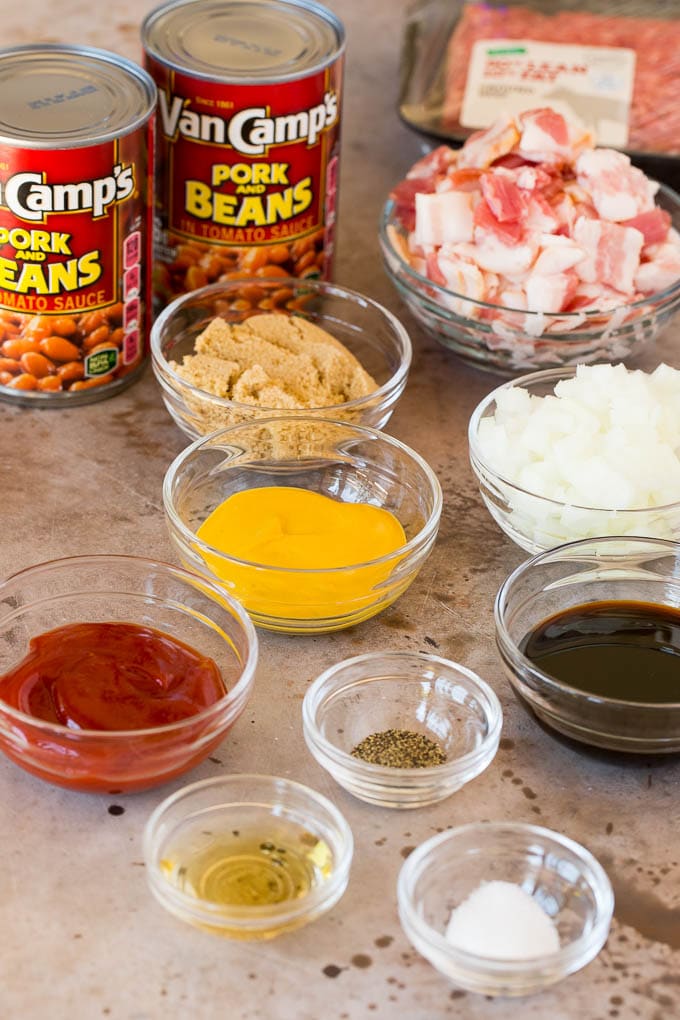 Recipe ingredients including bacon, ground beef and bowls of seasonings.