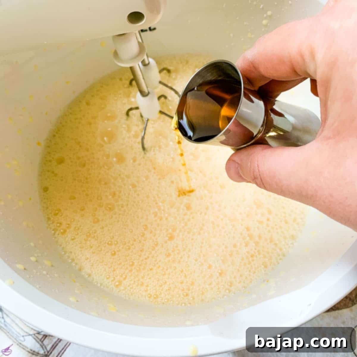 Carefully add the alcohol of your choice, such as vanilla vodka, and a good shot of cognac or brandy to the blended mixture.