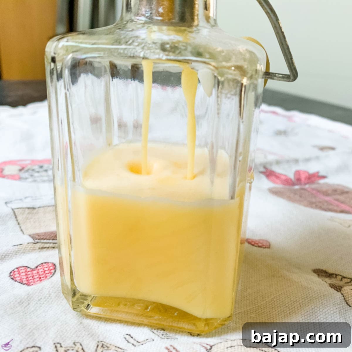 Carefully bottle your freshly made homemade advocaat egg liqueur, shaking often to keep it well combined.