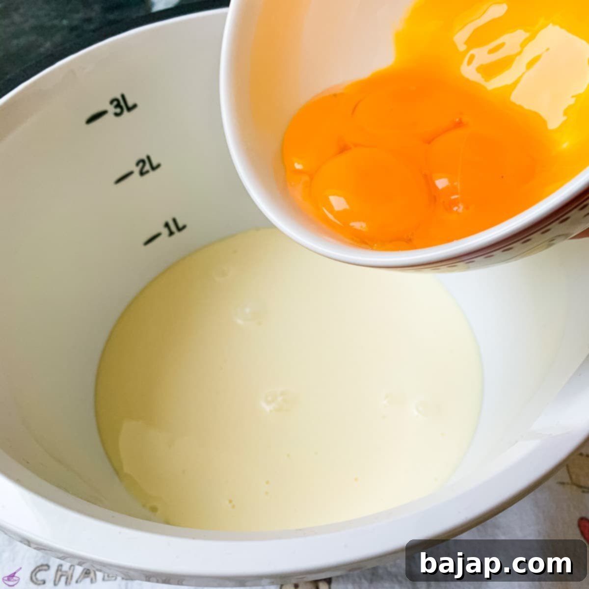 Next, add the fresh egg yolks to the mixture for richness and color.