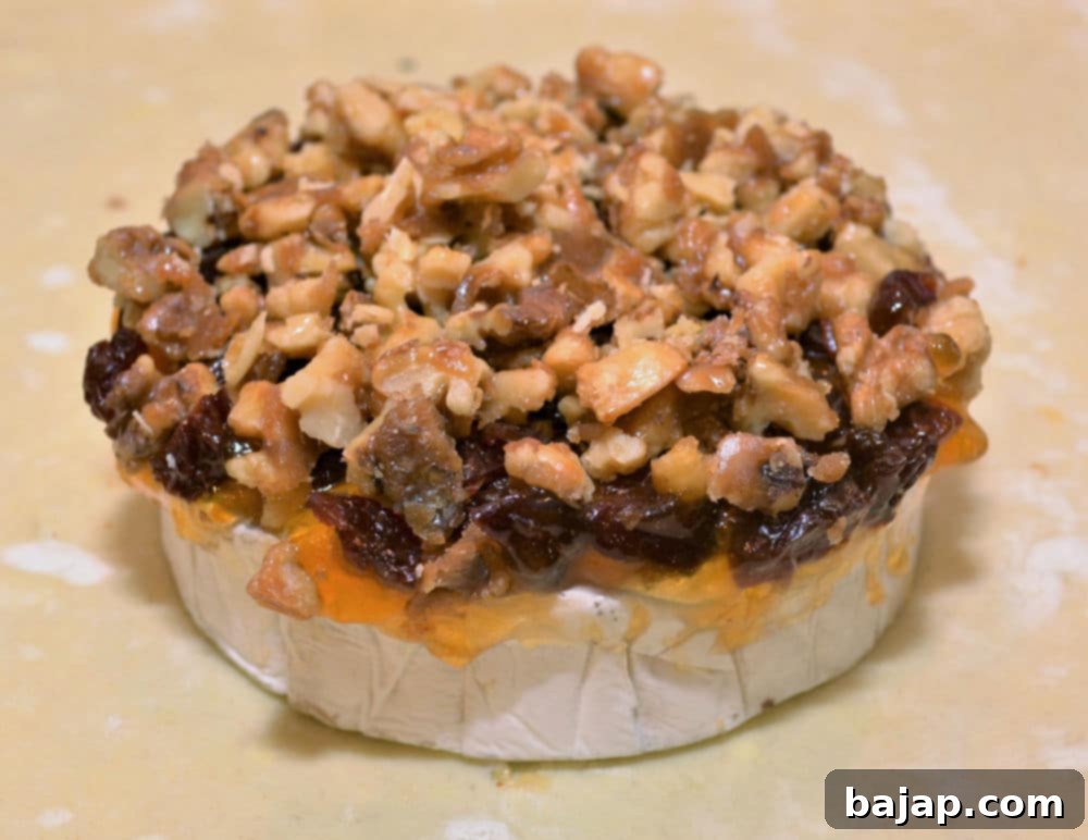 This simple yet elegant and impressive appetizer is perfect for get-togethers, small parties, and holidays. With apricot preserves, dried cherries, and candied walnuts nestled in a flaky, buttery puff pastry on top of warm, gooey brie cheese, this indulgent appetizer makes for a well-rounded, flavorful snack that everyone will love. The richness of the cheese, sweetness of the jam, tartness of the cherries, and nuttiness of the walnuts creates a perfect contrast both in flavor and texture.