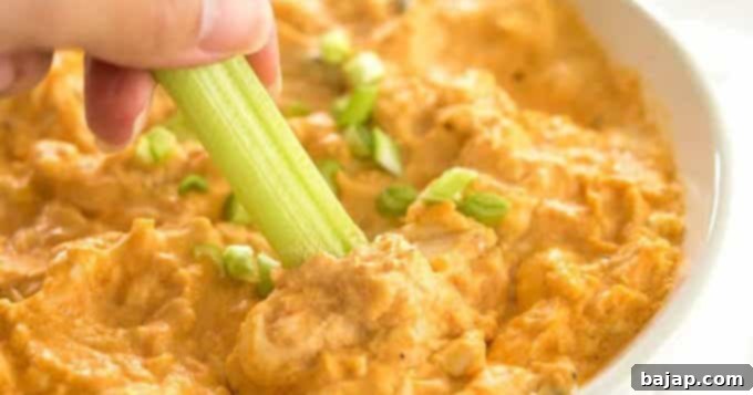 If you love buffalo chicken wings, then this buffalo chicken dip is for you! Shredded chicken is mixed with cream cheese, hot sauce, ranch dressing, and topped off with cheese and served hot and melty. Only 5 ingredients and you've got a winning appetizer perfect for tailgate parties, backyard get-togethers, and more.