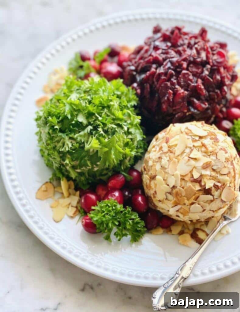 Caramelized onions, sharp white cheddar and minced garlic create the base for this Holiday Cheese Ball Trio decked out in fresh parsley, cranberries and almonds. It's a holiday appetizer you'll love!