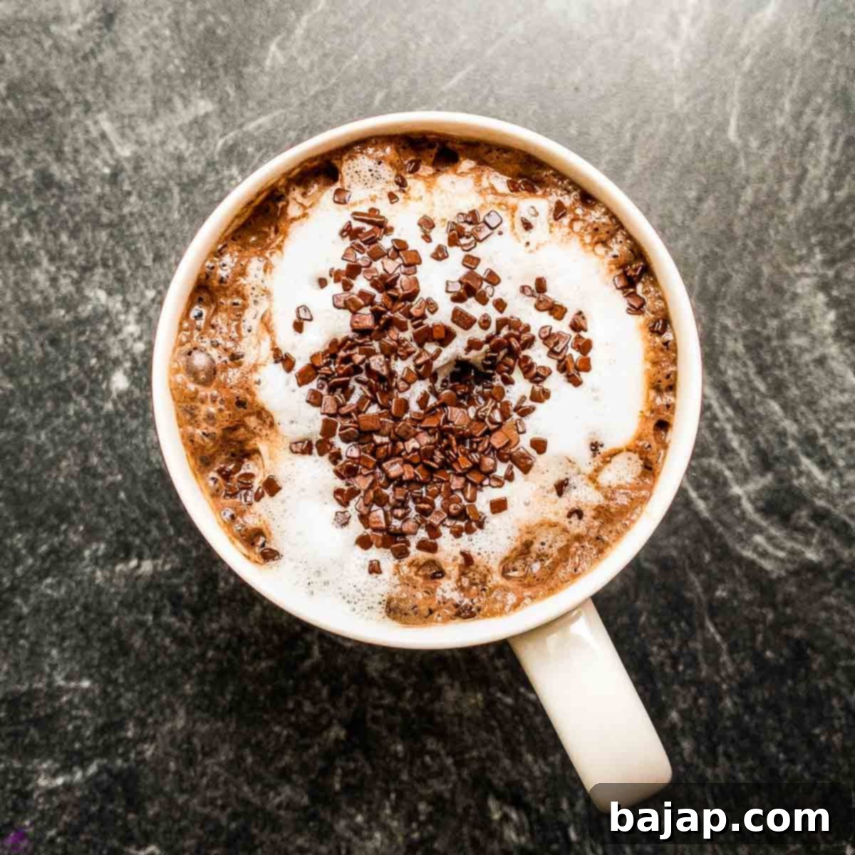 Hot chocolate topped with milk foam and generous chocolate sprinkles