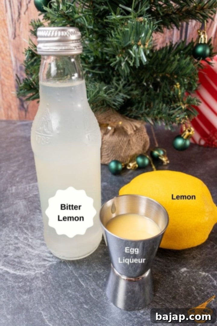 An assortment of fresh ingredients, including eggnog, bitter lemon, and lemons, laid out for a Snowball cocktail preparation.