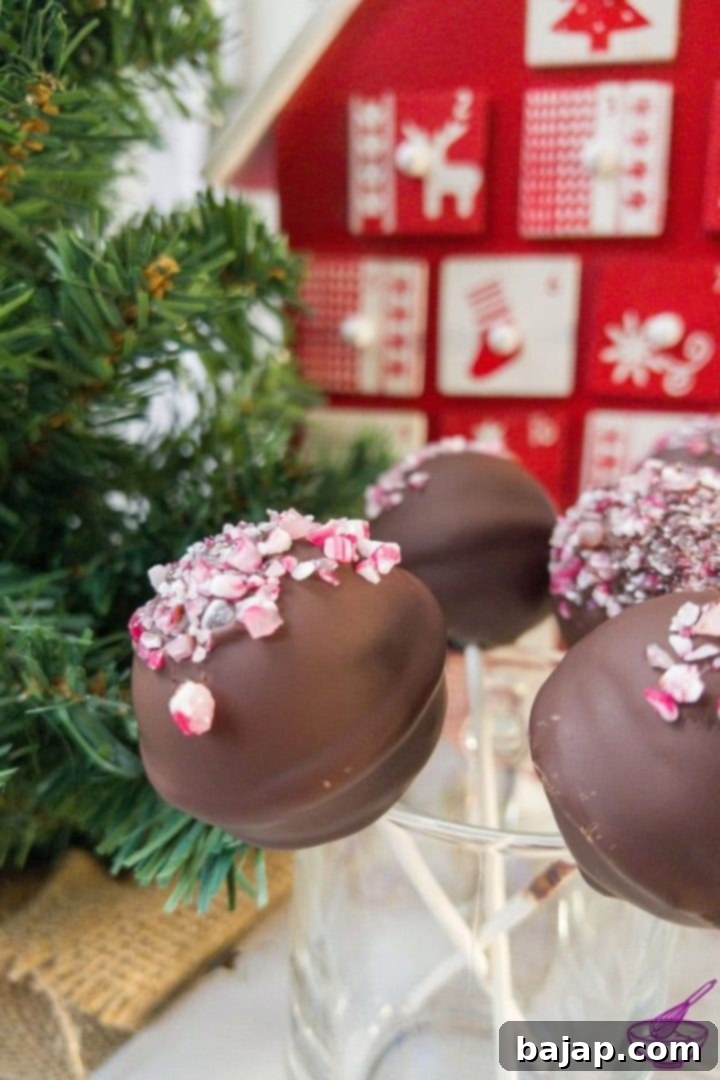 Beautiful and delicious Oreo candy cane cake pops, perfect for holiday gatherings