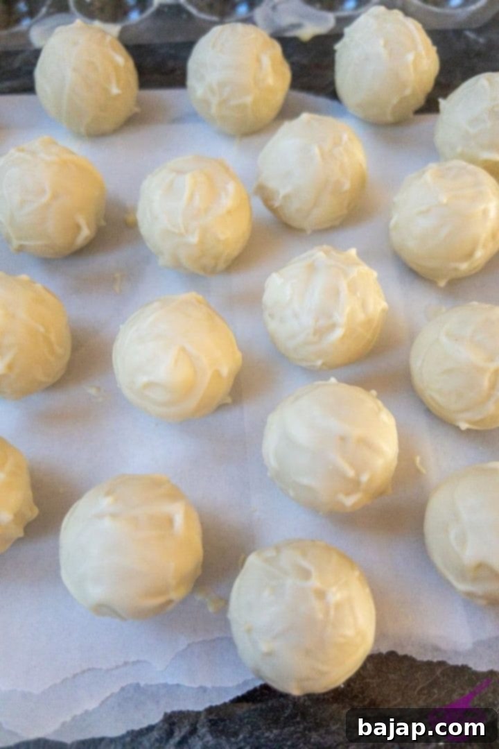 White chocolate covered chocolates with dark cinnamon ganache, ready for decoration