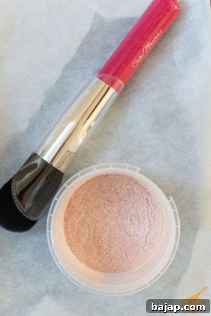 Dusting brush and edible pink glitter powder for decorating white chocolate truffles