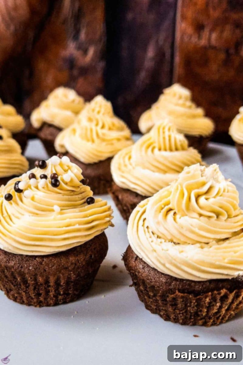 Boozy Baileys Salted Caramel Cupcakes with a delicious chocolate Sponge! Sprinkled with chocolate balls and caramel crunch.